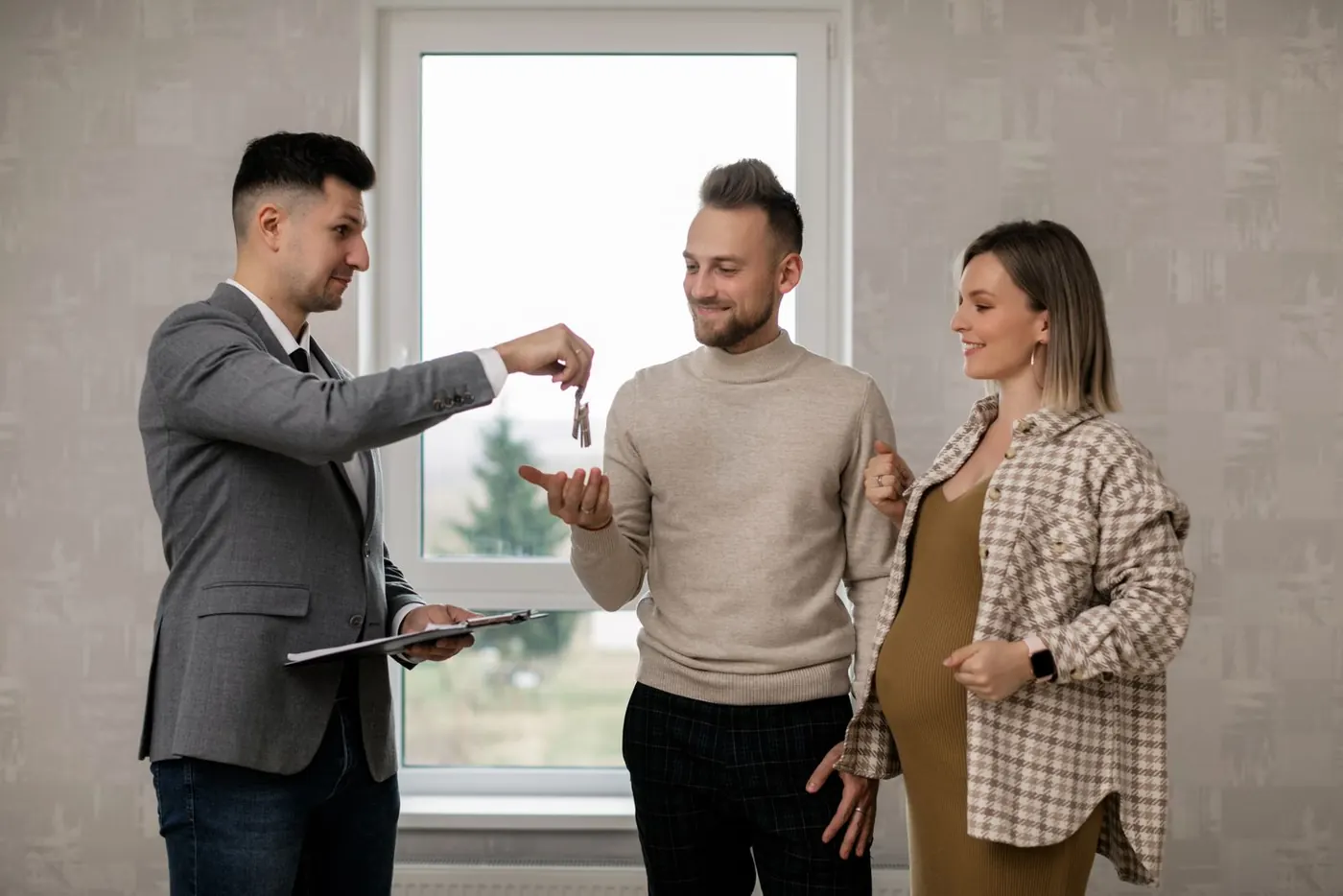 A couple receiving the keys to their new apartment