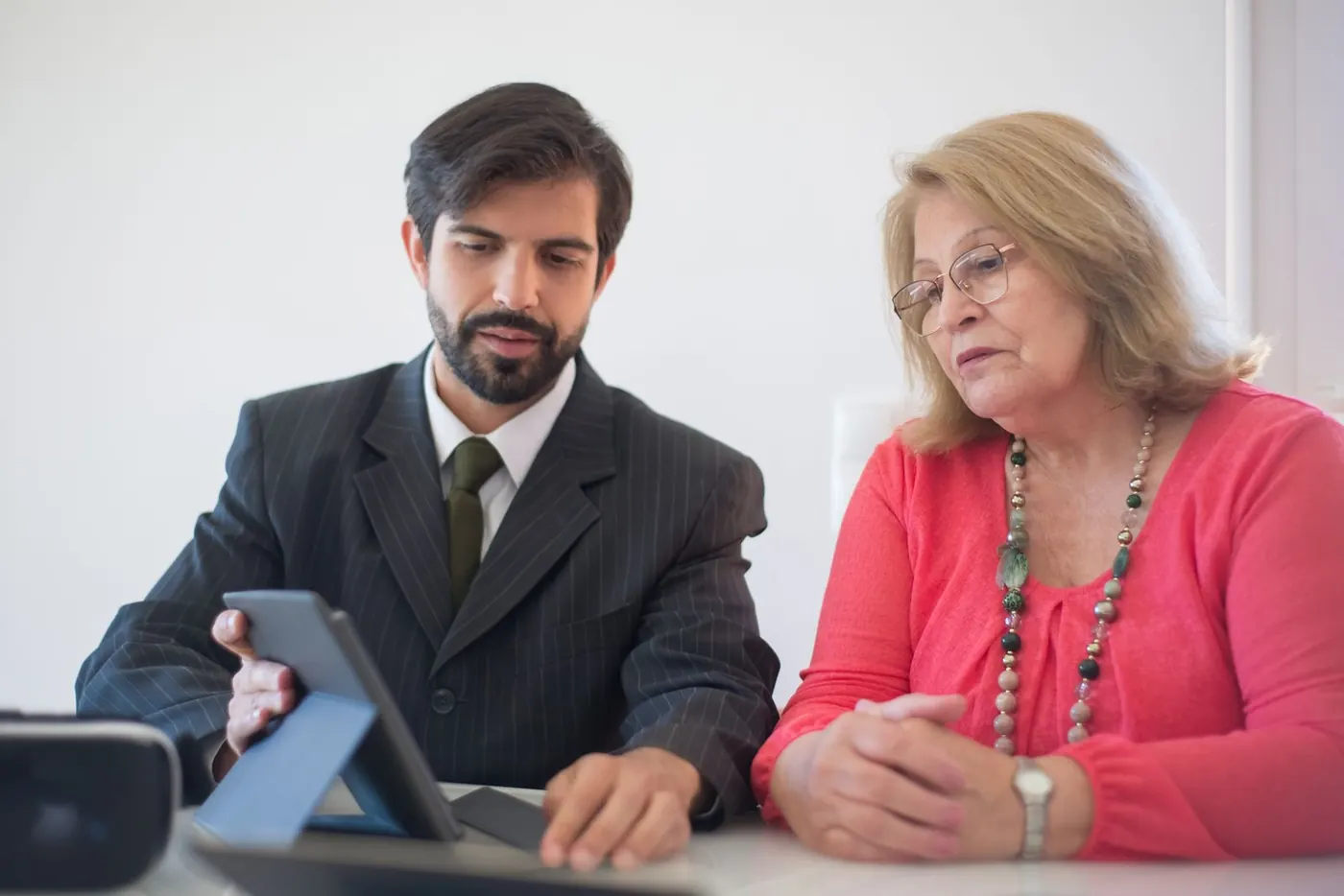 A property owner reviewing building details on a tablet with a manager